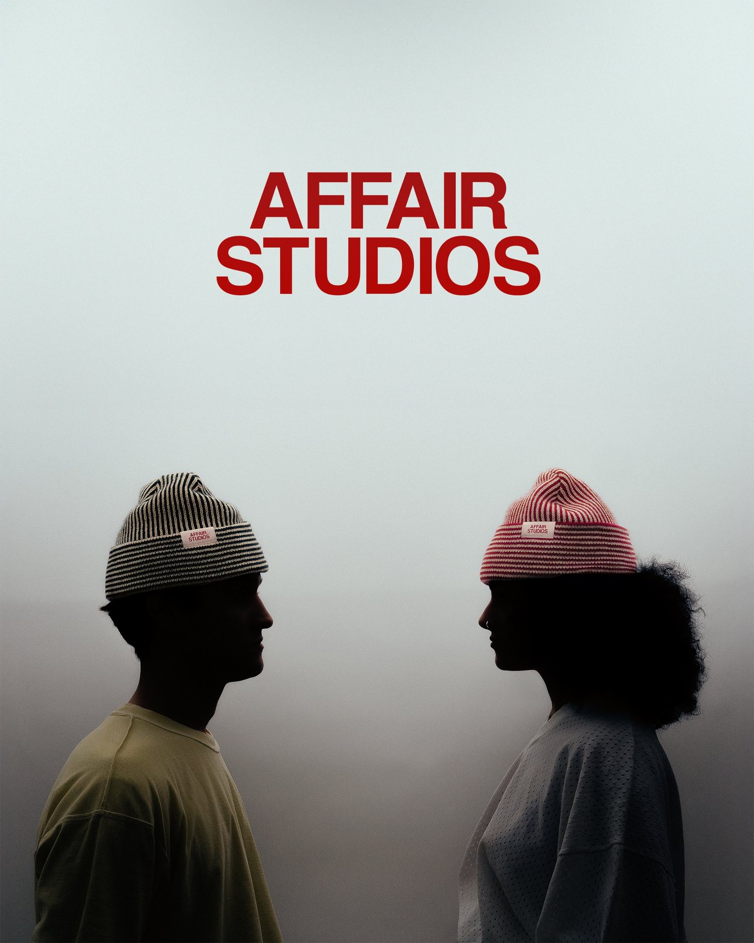 Two people in Affair Studios striped beanies face each other under the red AFFAIR STUDIOS wordmark